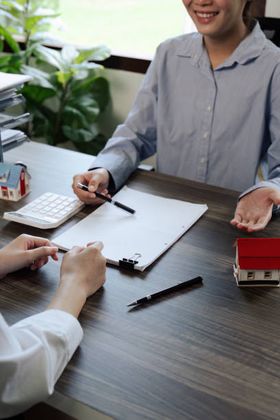 istock Real Estate Agent explain insurance and agreement contract to client before sign contract purchase house 1576146441