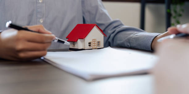 istock Real Estate Agent explain insurance and agreement contract to client before sign contract purchase house 1576148662