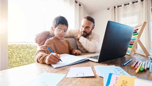 istock Learning, math education and father with kid in home with book for studying, homework or homeschool. Development, growth and boy with man teaching him how to count, numbers and elearning with laptop. 1576148731