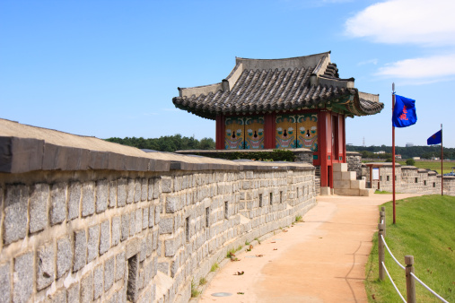 The Hwaseong Fortress wall was constructed in the late 18th century, and is a UN world cultural heritage site. The text on the flag translates to \