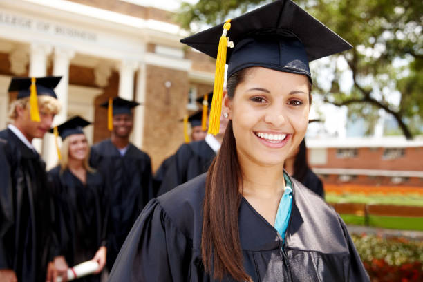 istock Group of smiling graduation students with college in the background 157615094
