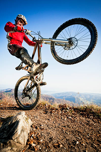 istock Extreme mountainbiker riding a wheelie 157615123