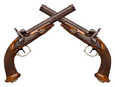 Antique Flintlock Pistols crossed at the barrel. Isolated on a white Background.