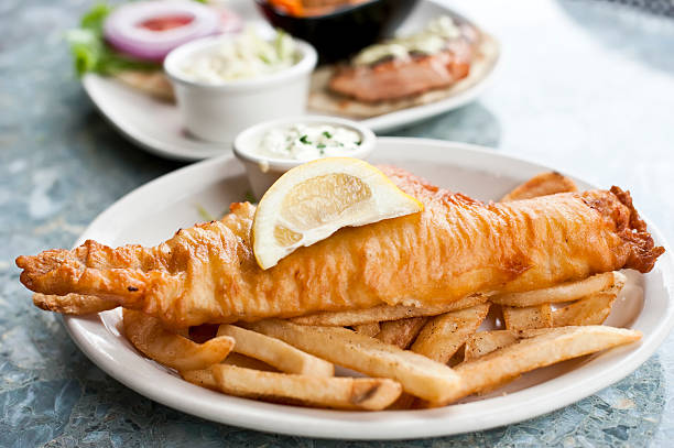 Fish and chips Close up picture of a plate containing fried fish and chips hake stock pictures, royalty-free photos & images