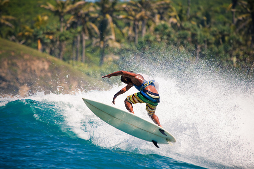 surfing on ocean wave, jump