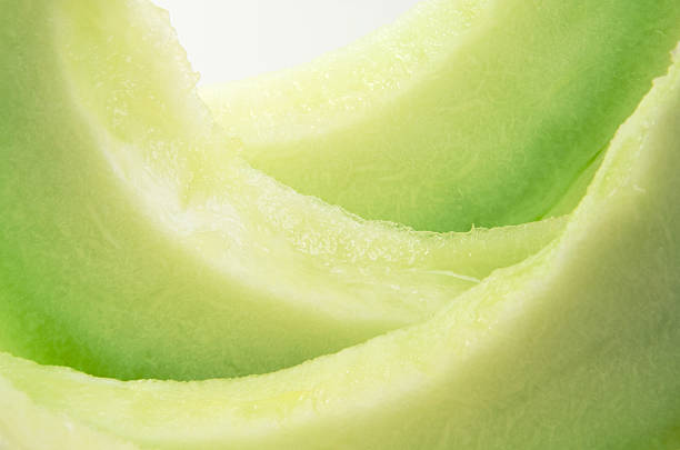 Fresh Ripe Honeydew Melon Slices Honeydew melon slices up close and in abstract.  honeydew melon stock pictures, royalty-free photos & images