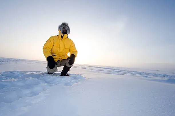 Photo of Arctic Fog.  Man in a Parka on the Snow