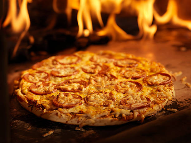 istock Pepperoni Pizza in a Wood Burning oven 157615376