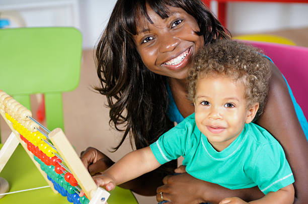 istock African American Woman And Baby Smiling While Playing 157615604