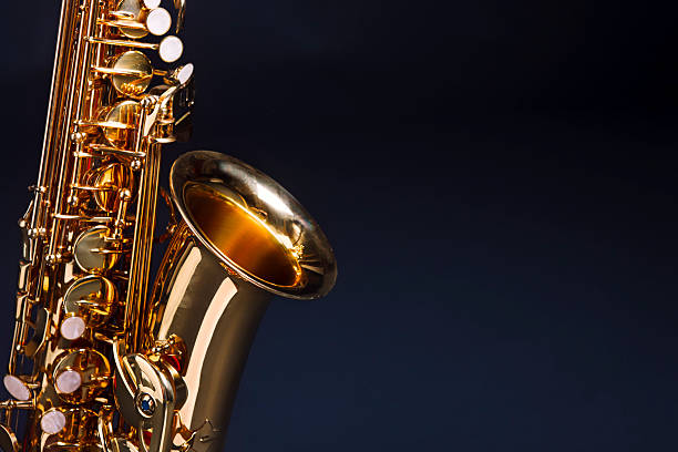istock Making beautiful music: golden saxophone against deep blue 157615683