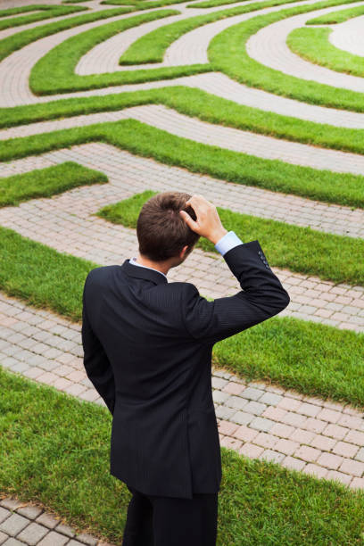 istock Maze with Confused Businessman Pondering Strategic Path and Occupation Solutions 157615697