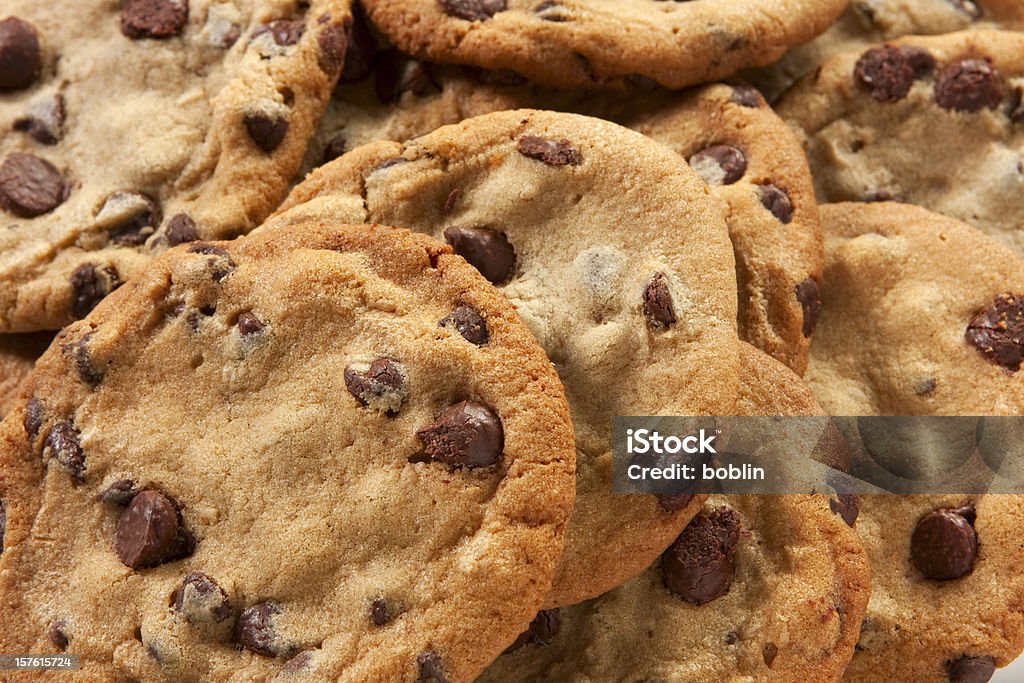 Slightly overdone chocolate chip cookies in a messy pile A plate of freshly baked chunky chocolate chip cookies. Cookie Stock Photo
