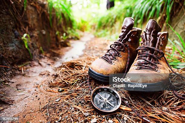 Worn Hiking Boots And Compass On Muddy Walking Trail Stock Photo - Download Image Now