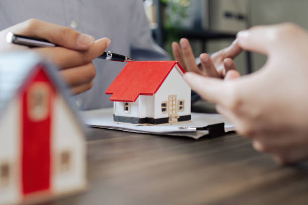 istock Real Estate Agent and client talking about Property insurance and security concept about house to client before sign contract. 1576158267