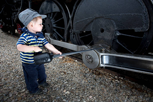 istock Young Boy Playing Mechanic on a Old Steam Train. 157615933