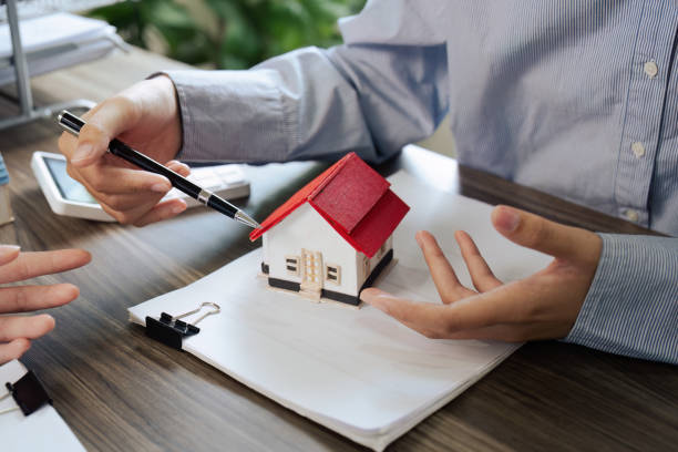 istock Real Estate Agent and client talking about Property insurance and security concept about house to client before sign contract. 1576159875