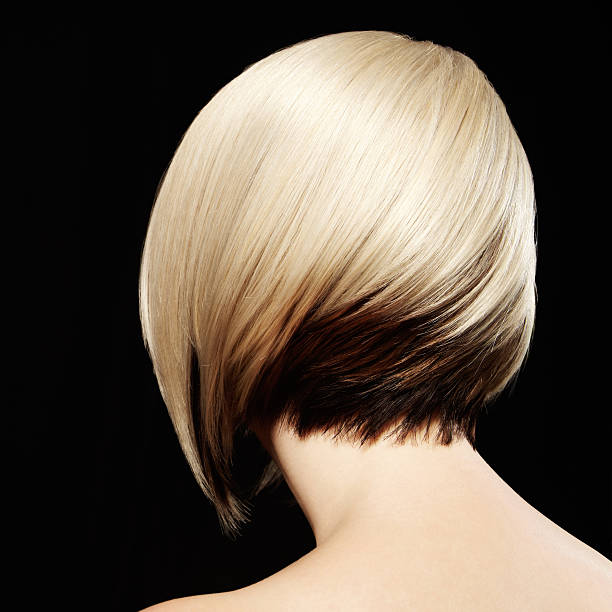 Rear View of Woman with Two-Toned Hairstyle. Black Background. stock photo