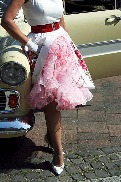 istock Woman with petticoat leaning on car 157616263