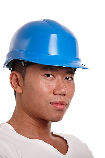 Young asian construction worker in hardhat stock photo