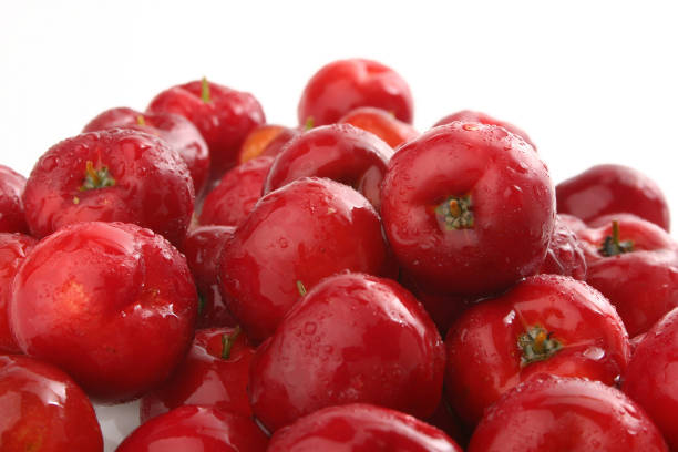 Ripe cherries. A woman is holding a bowl with a ripe cherry in her hands