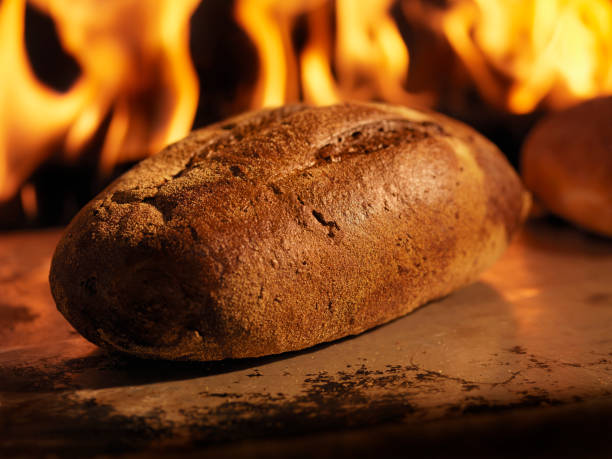 istock Pumpernickel Bread in a Wood Burning oven 157616806