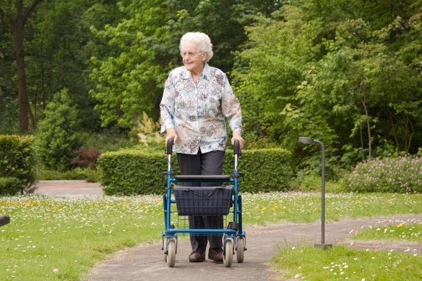 senior woman with walker in the park - for more  click here 