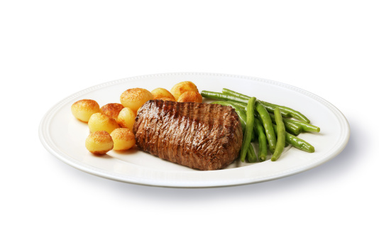 diner on a plate, filet mignon with potatoes and green beans