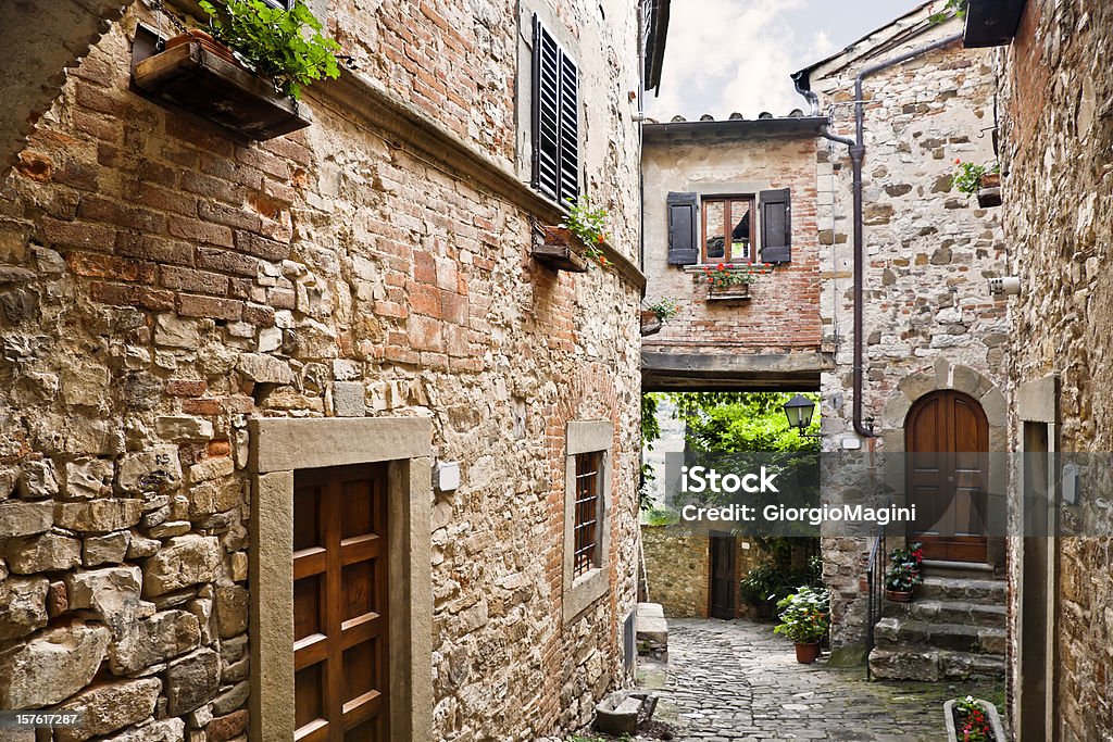 Ancient Tuscan Village in the Chianti Region, Italy Wideangle view of an alley in the ancient town of Montefioralle near Greve in Chianti (Tuscany, Italy). Italy Stock Photo