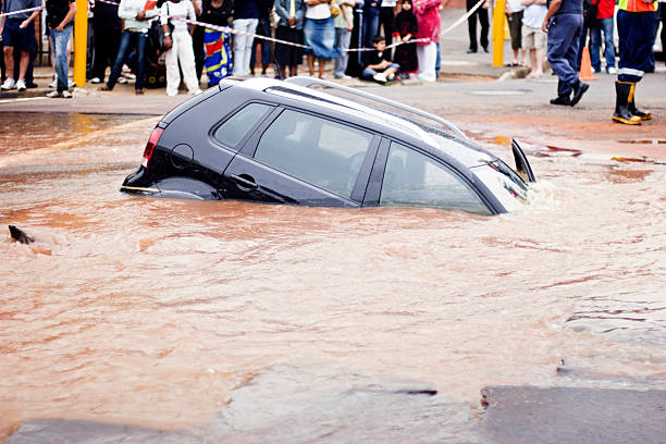 istock Car slips under muddy water in flooded street 157617418