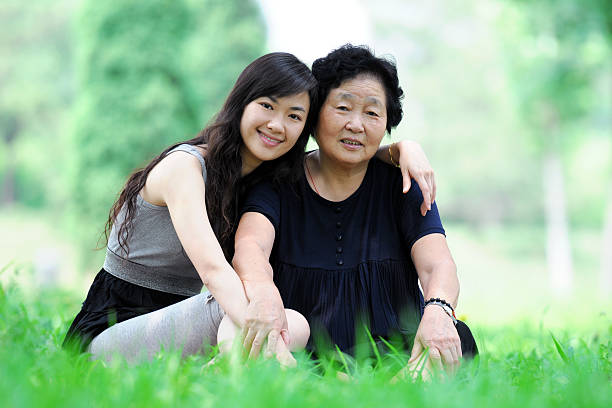 Two Generation - XLarge Two generation asian people sitting together china chinese ethnicity smiling grandparent stock pictures, royalty-free photos & images
