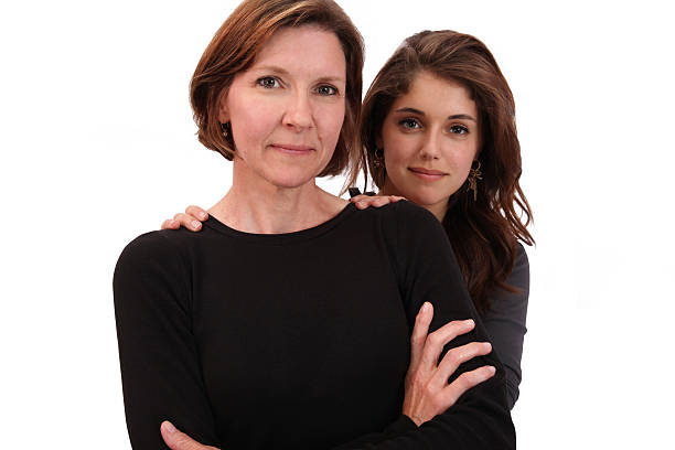Mother holding her daughter against a white background as the child wonders about everything