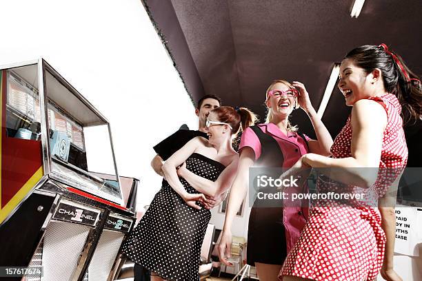 Retro 1950s Friends Dancing By The Jukebox In Soda Shop Stock Photo - Download Image Now