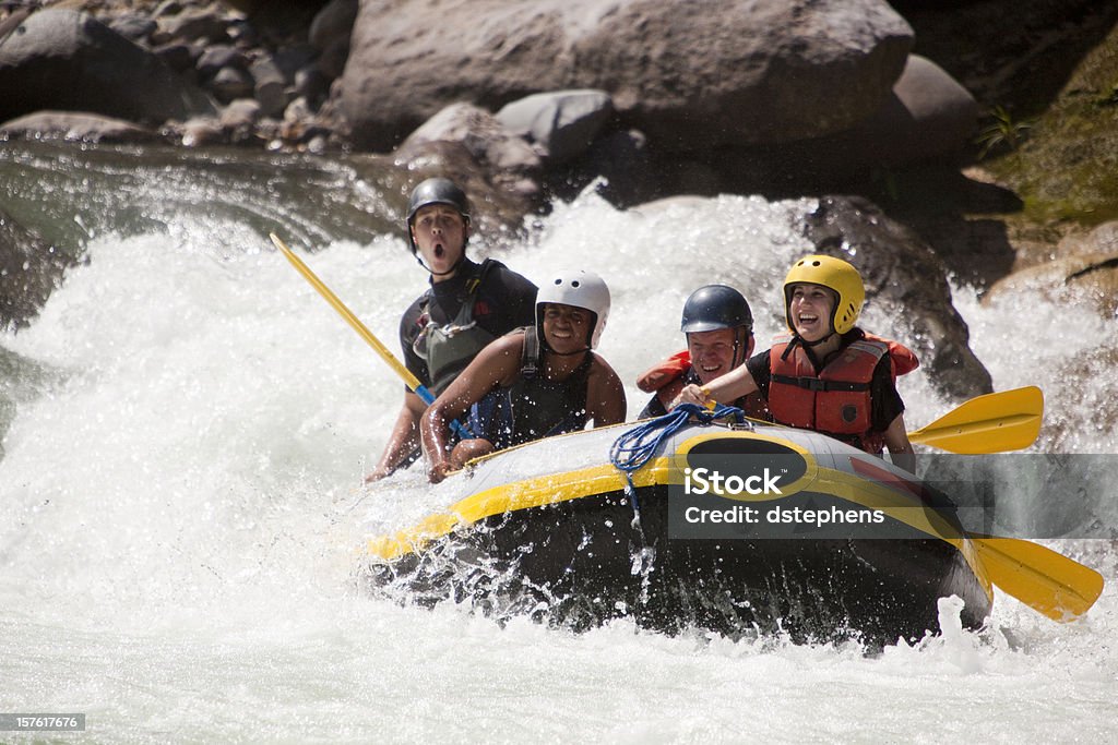 Whitewater rafting through rapids Happy group of friends rafting through whitewater rapids. Rio Congrejal, Honduras White Water Rafting Stock Photo