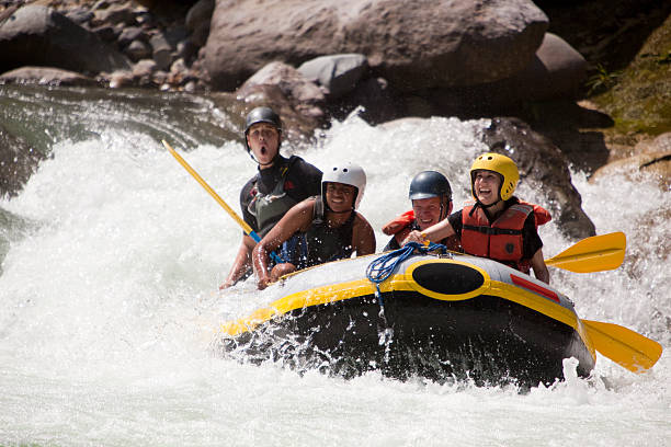 Whitewater rafting through rapids stock photo