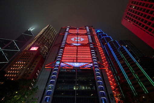 Hong Kong, China - April 24 2023: Headquarters of The HSBC Bank in Central with LED illumination night view, designed by Norman Foster