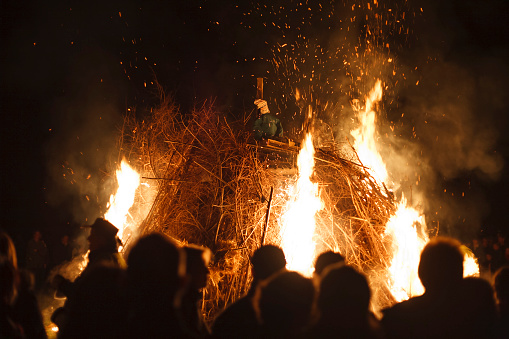 People watch as an effigy of Guy Fawkes burns on bonfire night in Surrey, England, UK. No recognisable faces