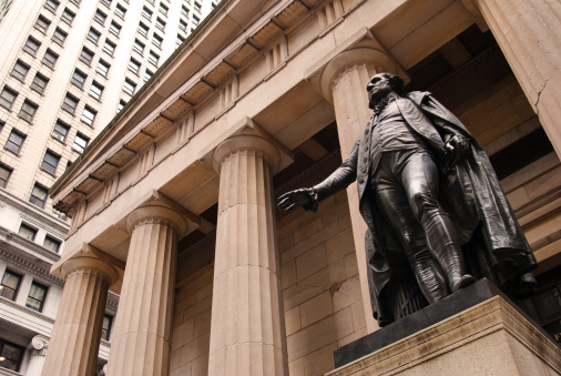 Looking upwards at the statue of George Washington outside of Federal Hall on Wall Street in New York City, New York.