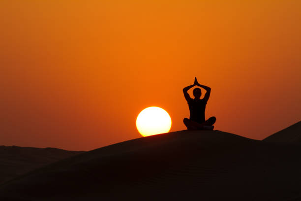 istock yoga on hill at sunset with place for text 157618041