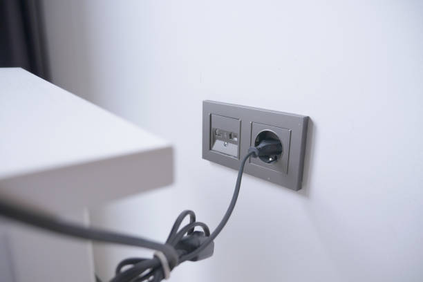 istock white color power cord cable plugged into wall 1576185910