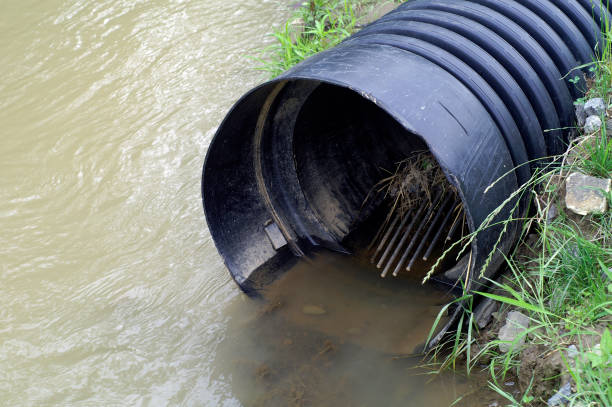 istock Drainage pipe next to a body of water 157619125