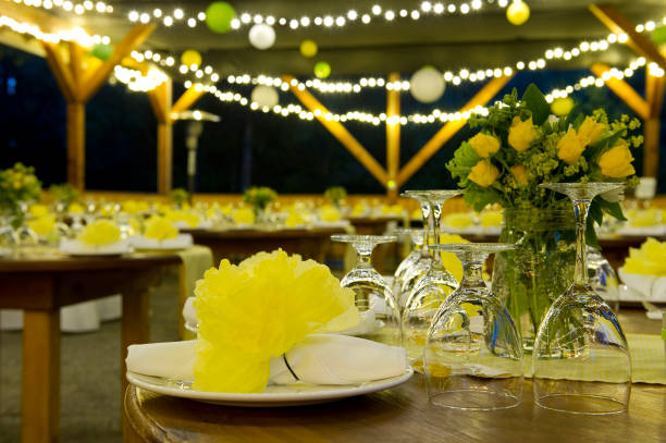 Night time wedding with yellow flowers and strings of light