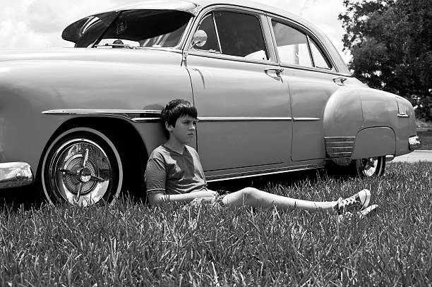 Portrait of a boy laying on the car in black & white picture  1959 photos stock pictures, royalty-free photos & images