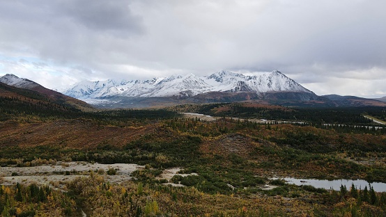 A scenic view of a picturesque valley with snow-capped mountains in the background. Alaska, USA.