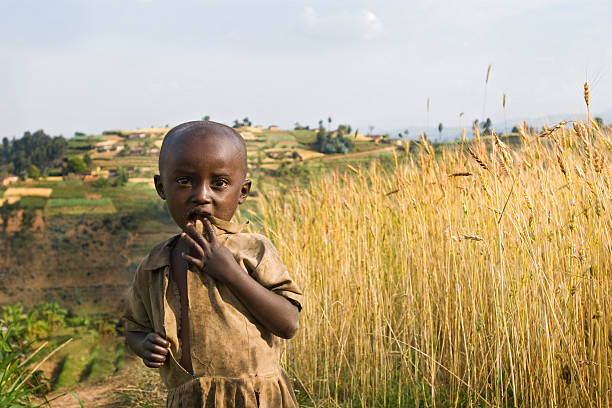 A malnourished African 3-year-old boy holding a sign that says \