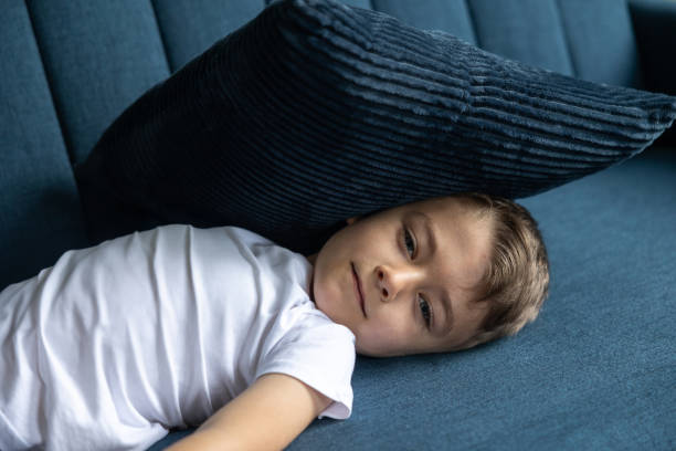 istock The boy lies on the couch with a pillow. 1576208206