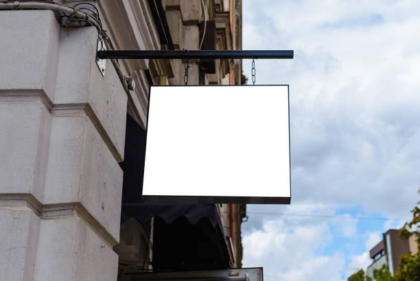 istock Blank white signboard mockup. Empty illuminated shop lightbox template mounted on wall. Mock up of illuminated blank signboard. Place for text, outdoor advertising, banner. 1576211641
