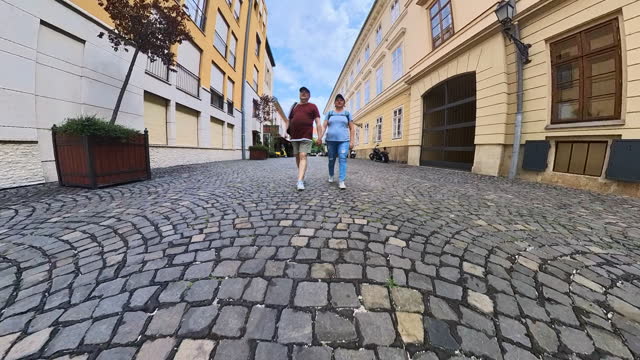 Mid-aged couple walking at Budapest streets.