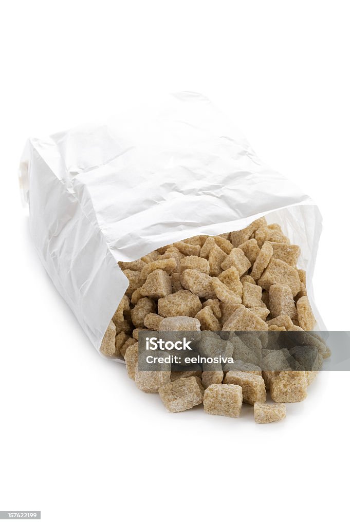demerara sugar cubes in a paper bag on white rough cut brown sugar cubes on white background Bag Stock Photo