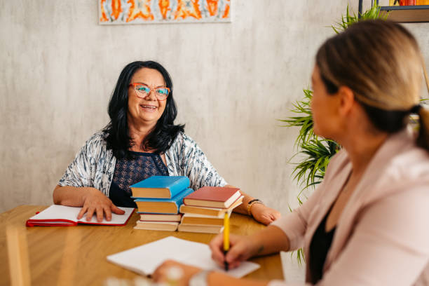 istock Two Female Teachers Grading Book Reports Indoors 1576227300