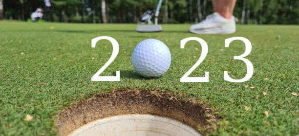 istock Golfer with 2023 golf ball at hole on golf course 1576227698
